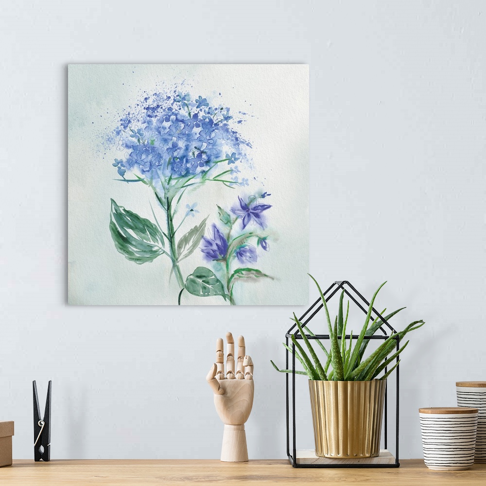 A bohemian room featuring A watercolor painting of blue flowers with speckled accents.
