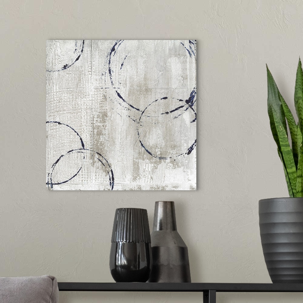 A modern room featuring Contemporary square painting of navy circular outlines on a textured tan and white background.