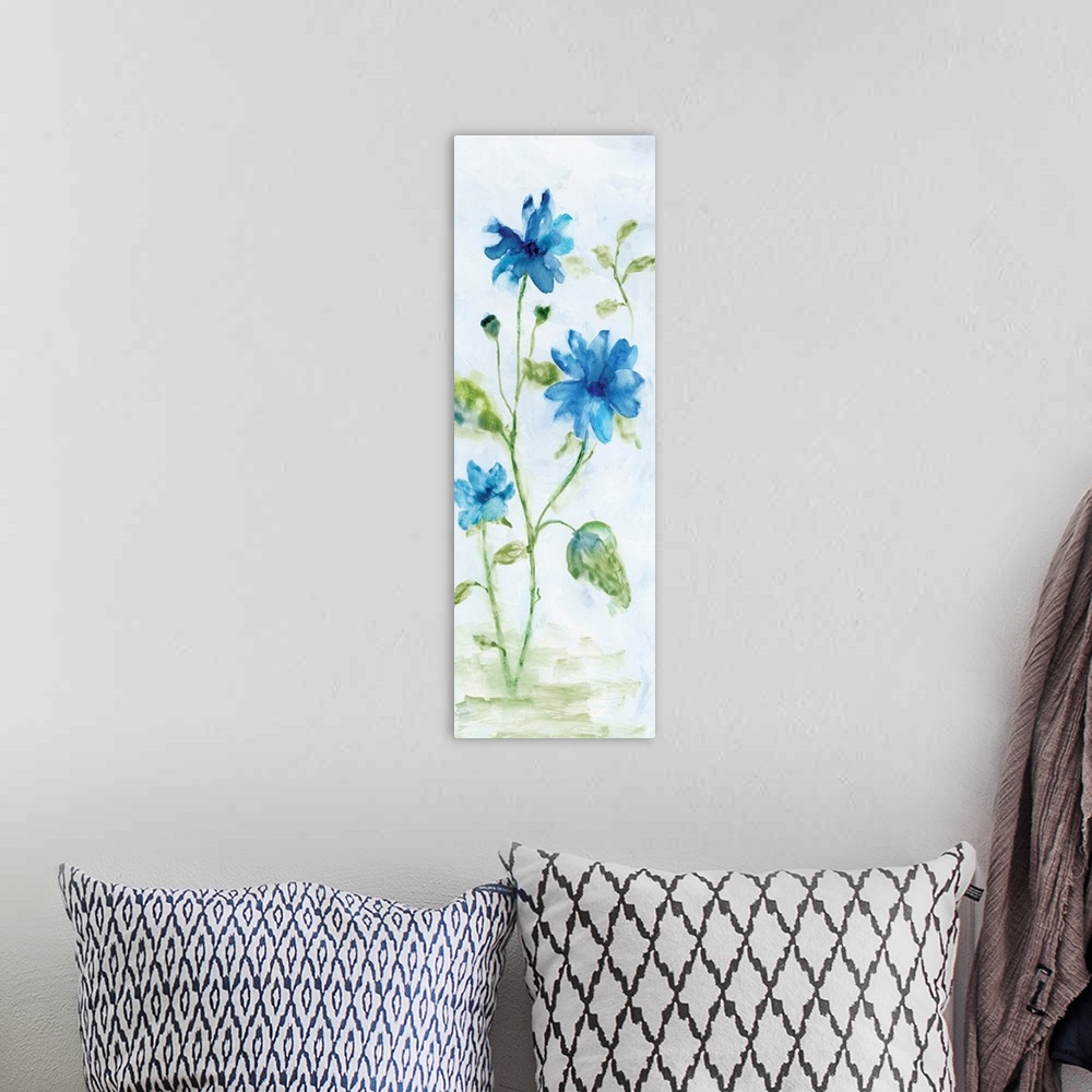 A bohemian room featuring Watercolor art print of bright blue flowers on a pale grey background.