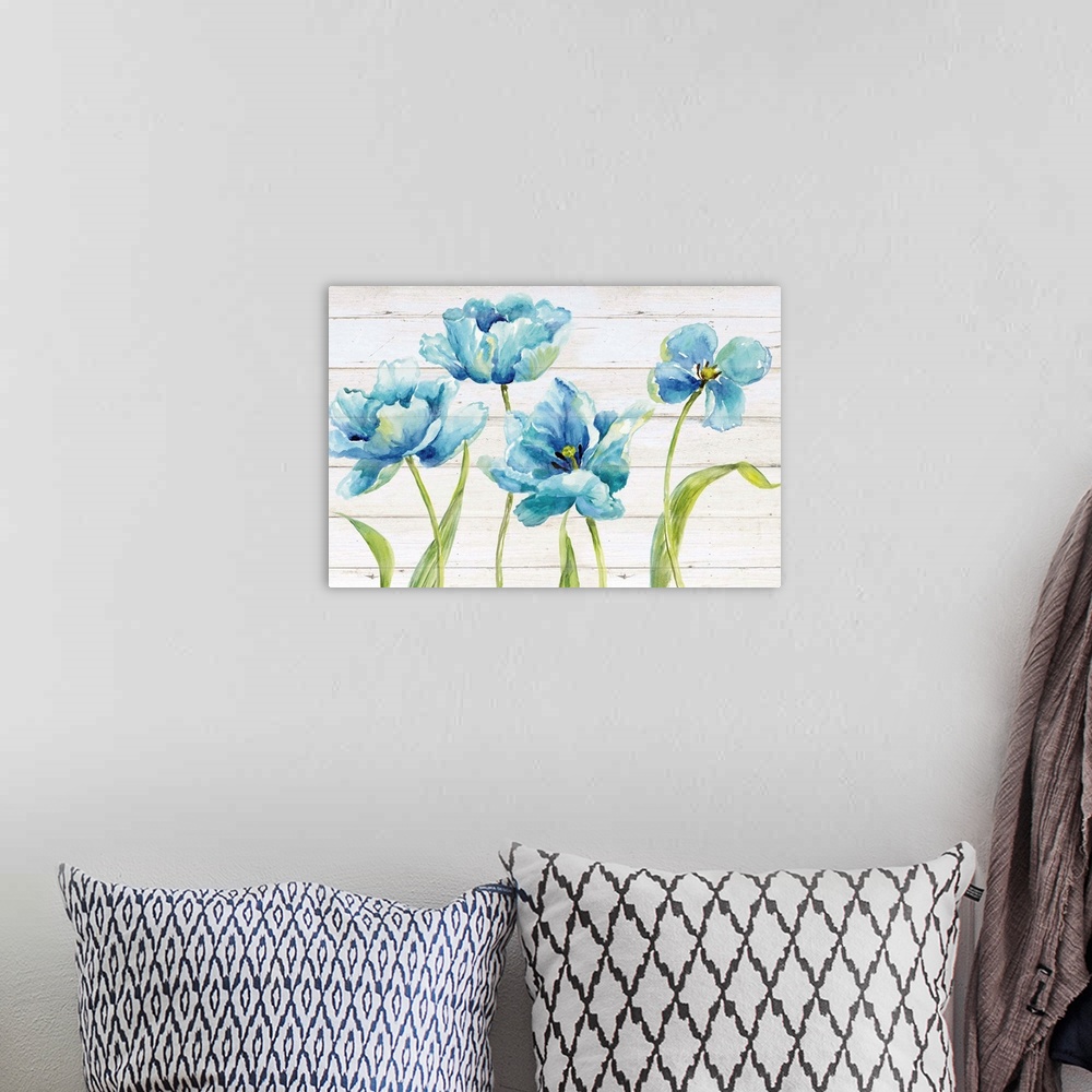 A bohemian room featuring Watercolor painting of four blue tulips on a distressed white shiplap background.