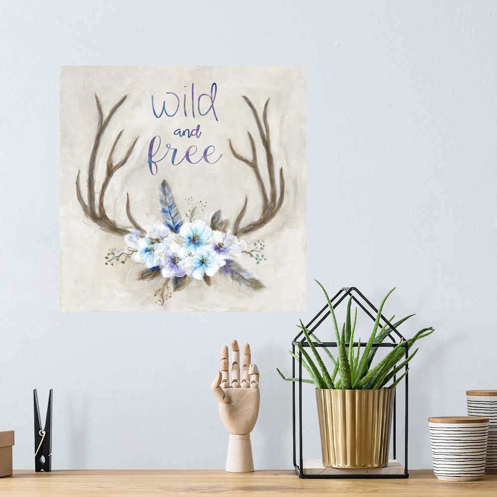A bohemian room featuring Square painting of antlers decorated with flowers and feathers and has the phrase "Wild and Free"...