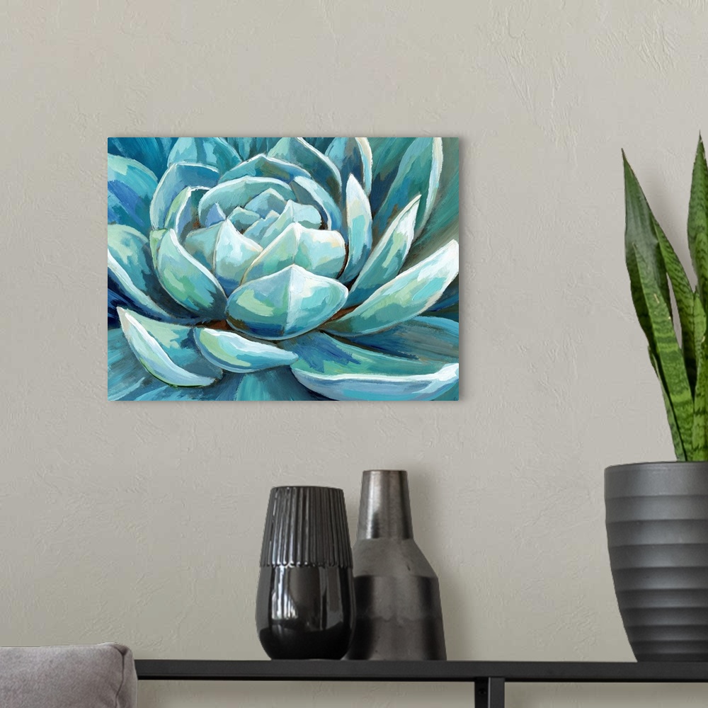 A modern room featuring A large horizontal close up image of succulents in shades of blue and green.