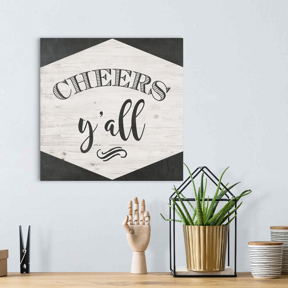 A bohemian room featuring The words "Cheers Y'all" are black lettering placed on a white shiplap trimmed with chalkboard te...
