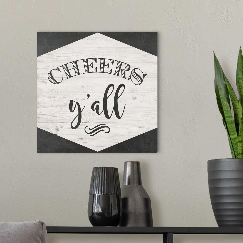 A modern room featuring The words "Cheers Y'all" are black lettering placed on a white shiplap trimmed with chalkboard te...