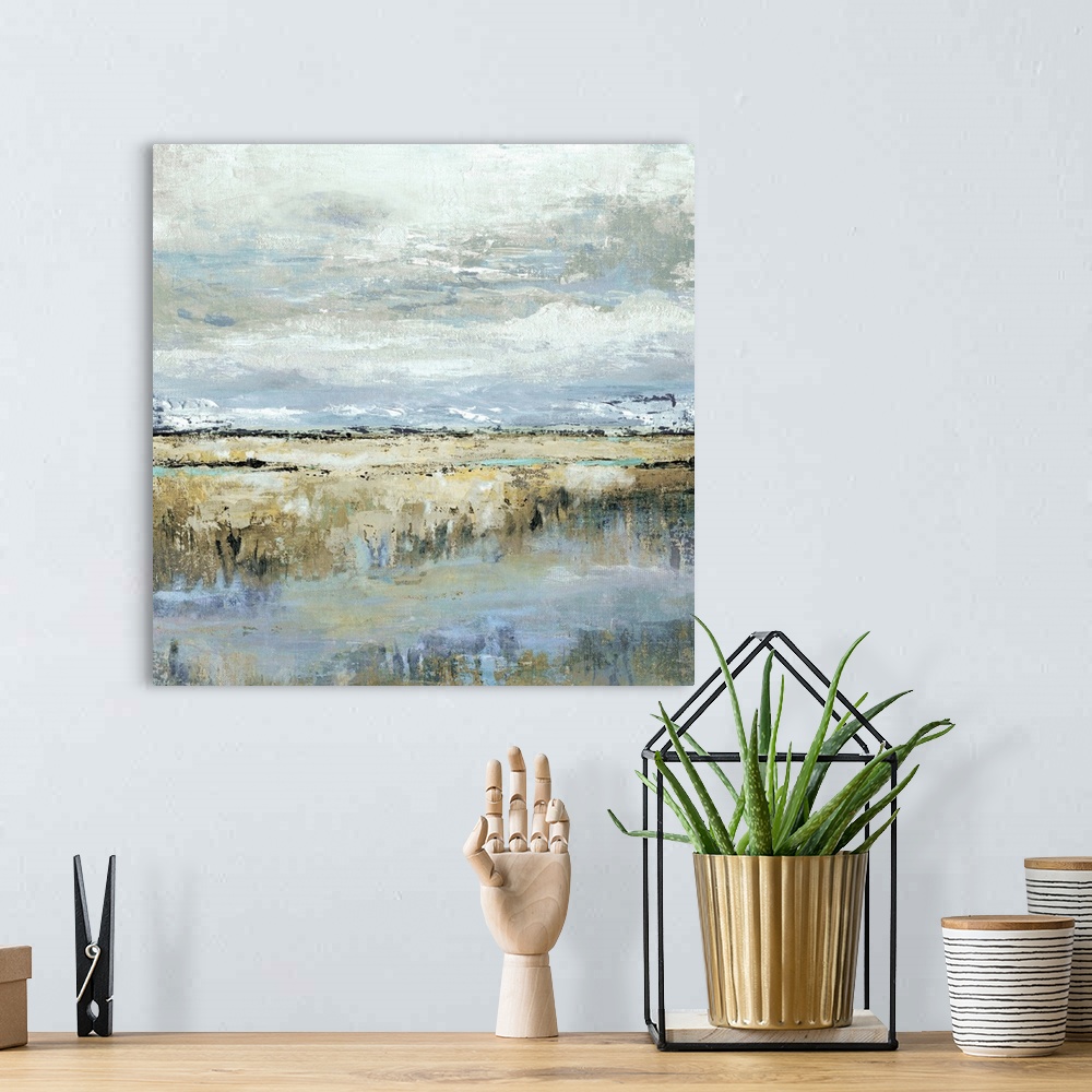 A bohemian room featuring Square abstract painting of a marsh landscape in shades of brown, blue, yellow, and grey.