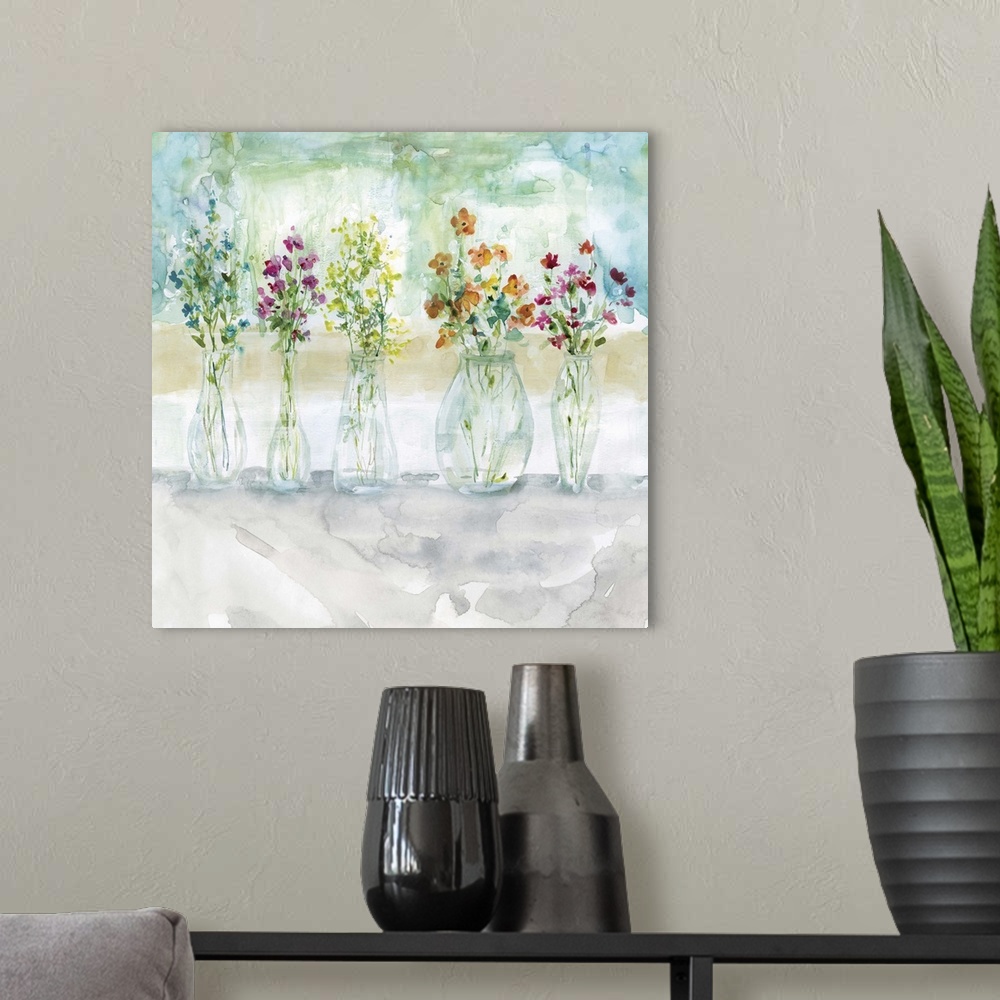 A modern room featuring Square watercolor painting of five vases filled with wildflowers.