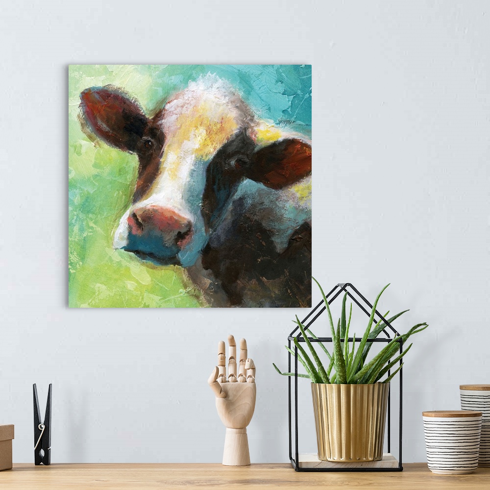 A bohemian room featuring A colorful painting of a cow.