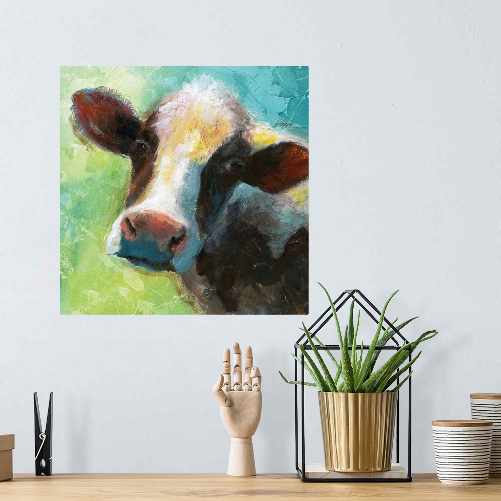 A bohemian room featuring A colorful painting of a cow.