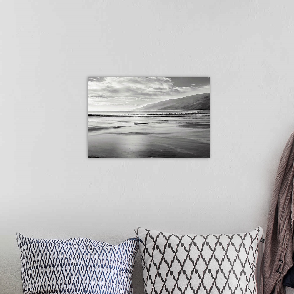 A bohemian room featuring Black and white seascape illustration with mountains in the background.