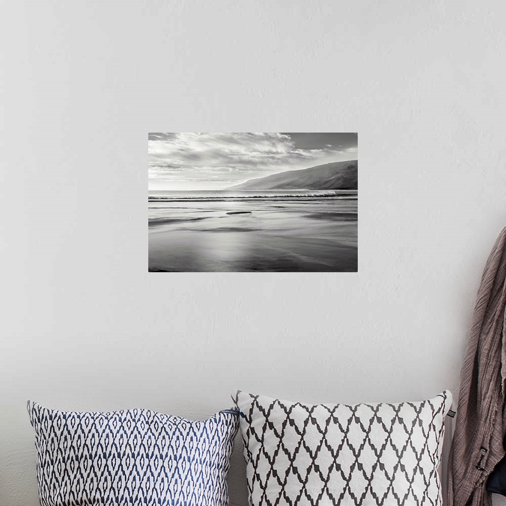 A bohemian room featuring Black and white seascape illustration with mountains in the background.