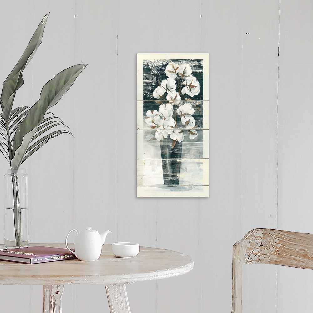 A farmhouse room featuring Long vertical artwork of a vase full of cotton bulbs with a rustic effect on white wood backdrop.
