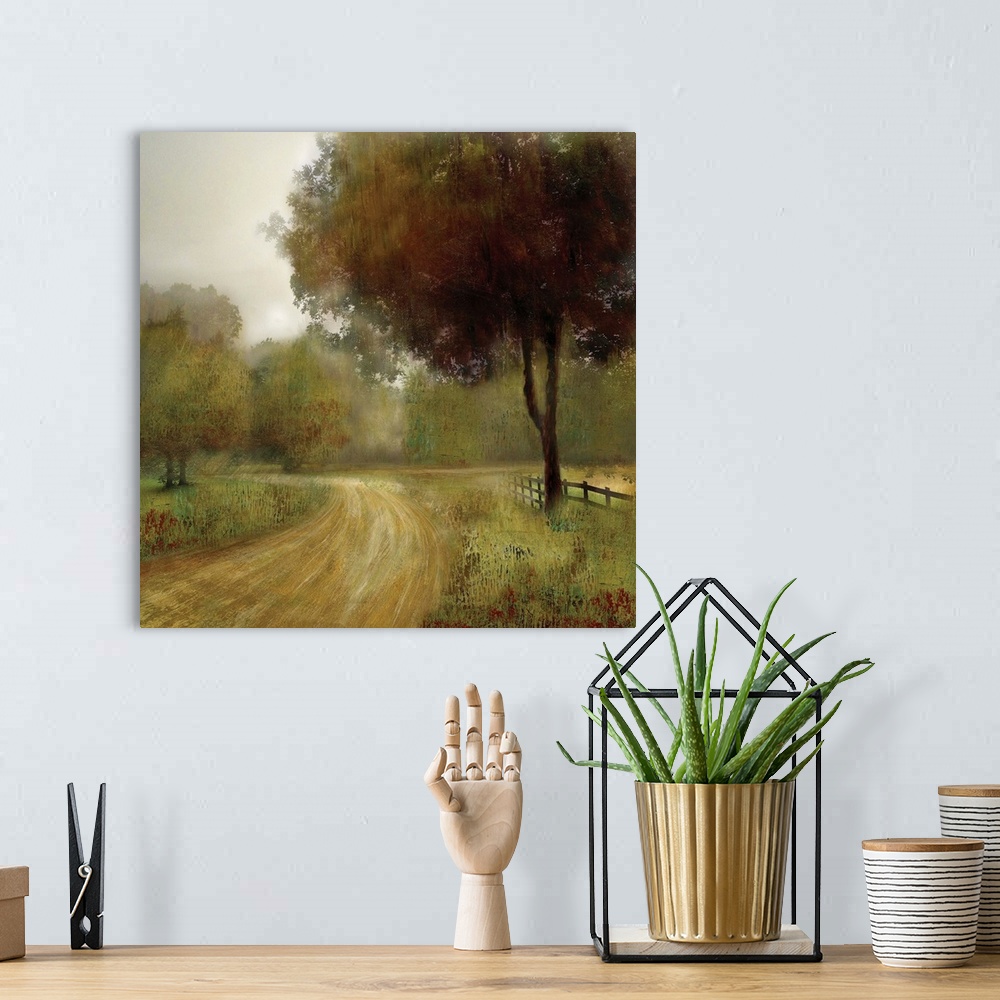 A bohemian room featuring A square artwork of a road going by a fenced field and tree.