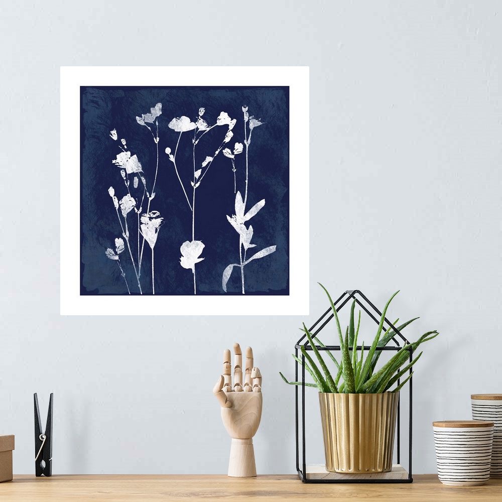 A bohemian room featuring Square cyanotype of white silhouetted flowers on an indigo background with a white boarder.