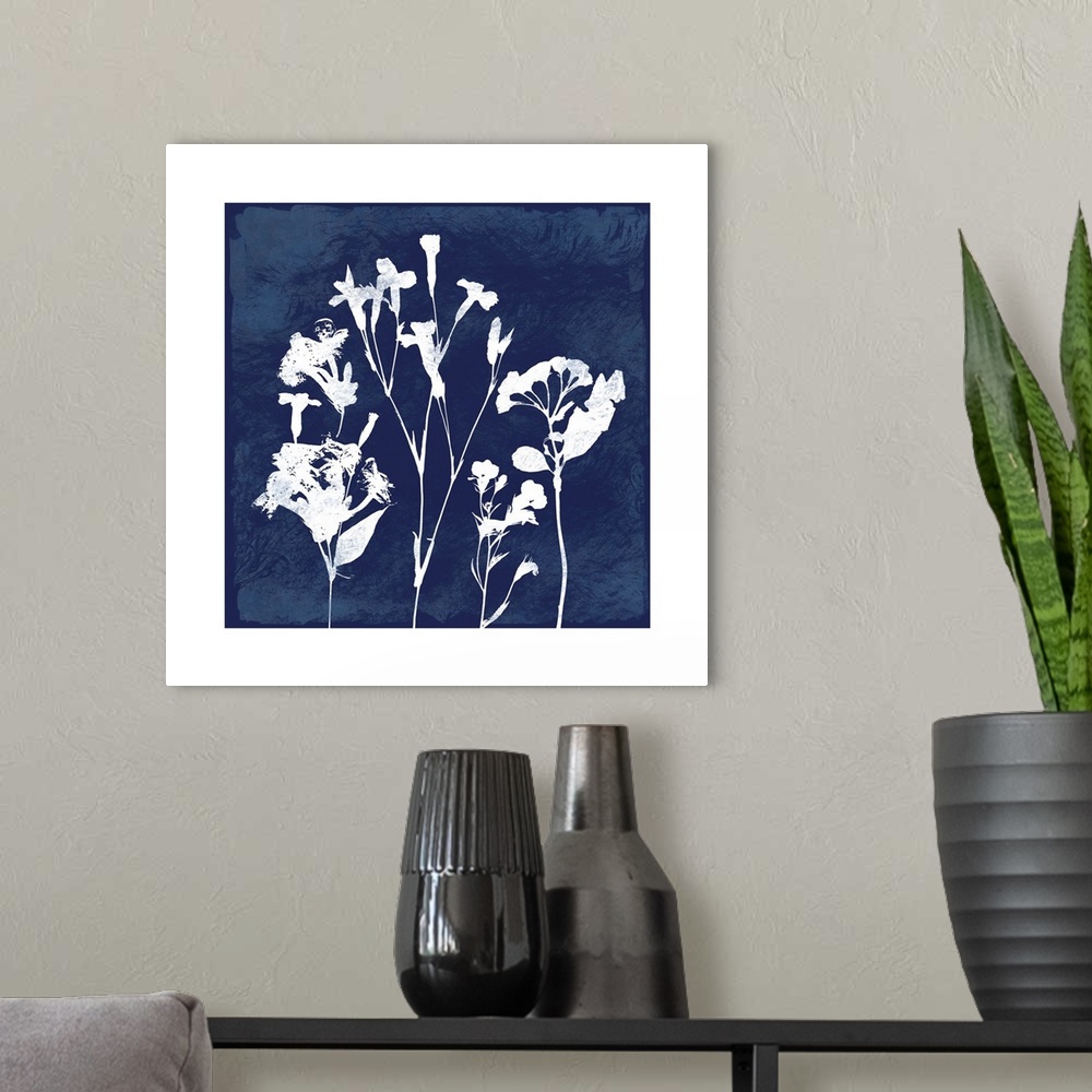 A modern room featuring Square cyanotype of white silhouetted flowers on an indigo background with a white boarder.