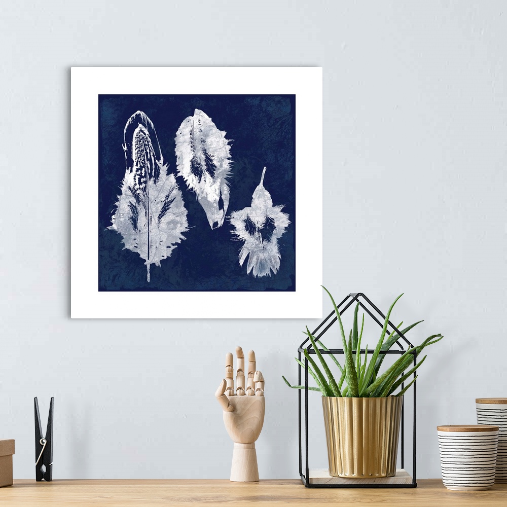 A bohemian room featuring Square cyanotype of white silhouetted feathers on an indigo background with a white boarder.