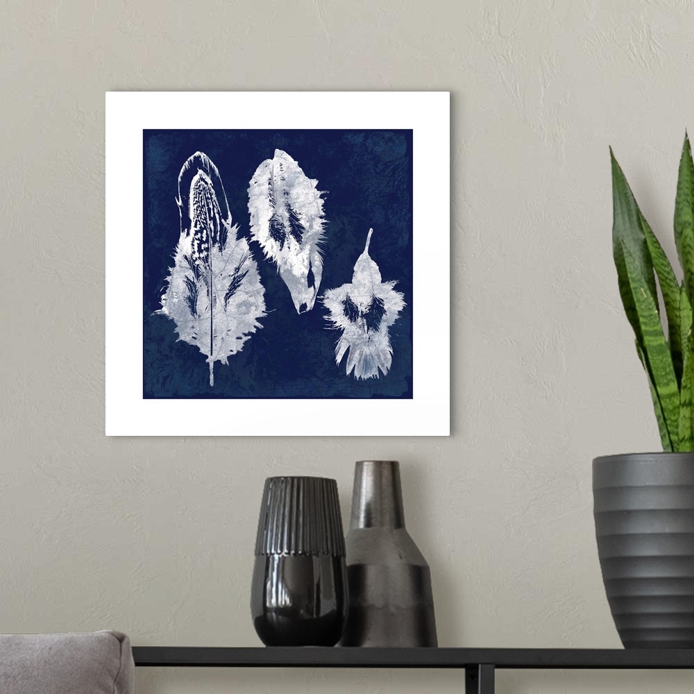 A modern room featuring Square cyanotype of white silhouetted feathers on an indigo background with a white boarder.