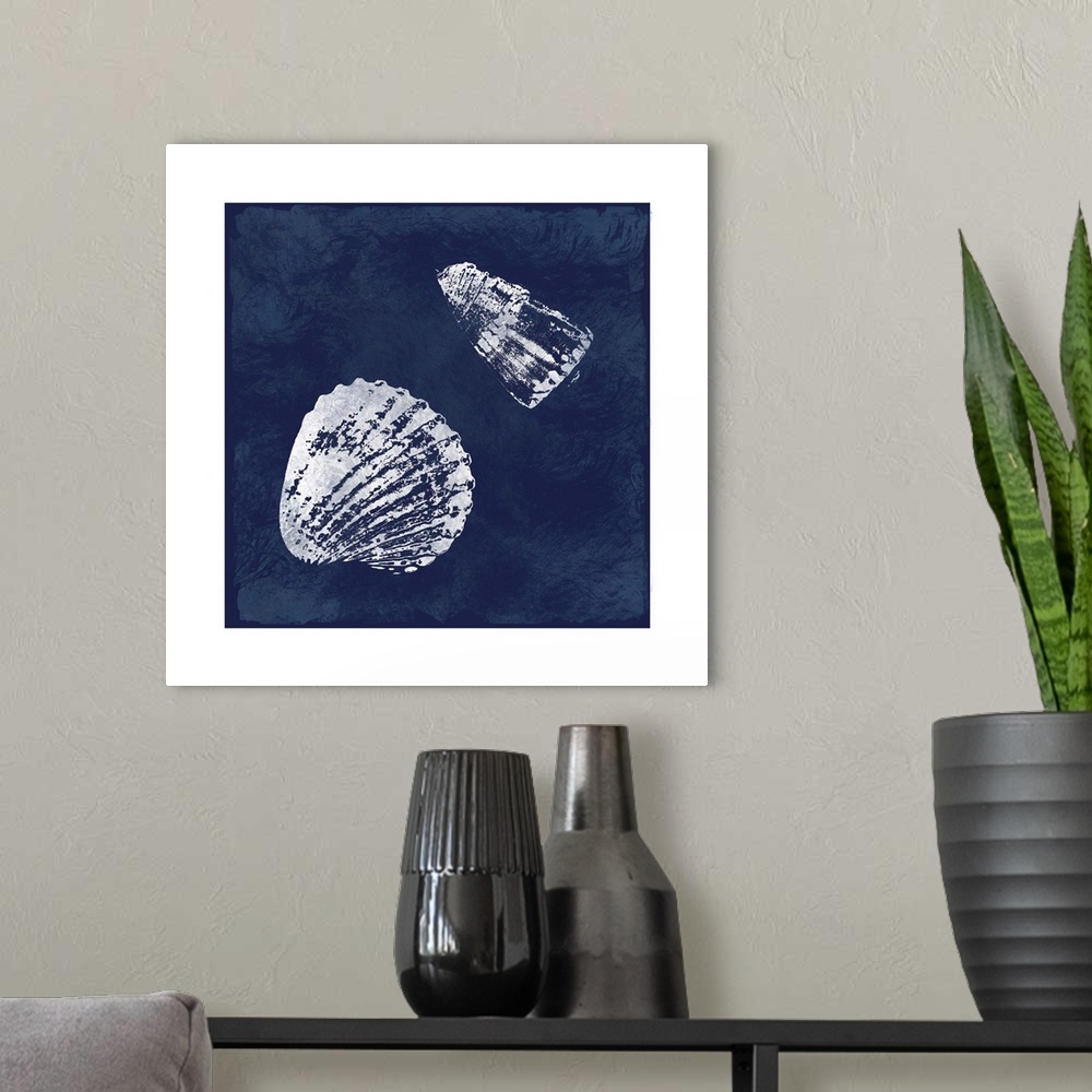A modern room featuring Square cyanotype of white silhouetted seashells on an indigo background with a white boarder.