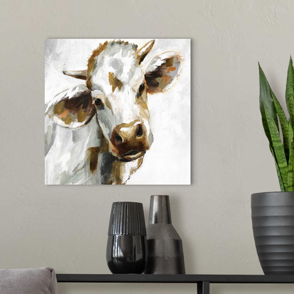 A modern room featuring Square painting of a brown, grey, and white cow.