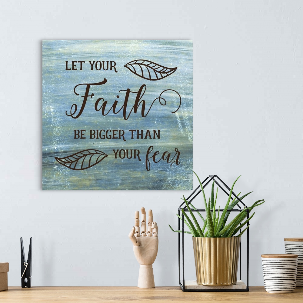 A bohemian room featuring Typography art of a religious sentiment with a leaf motif over a weathered blue and green backgro...