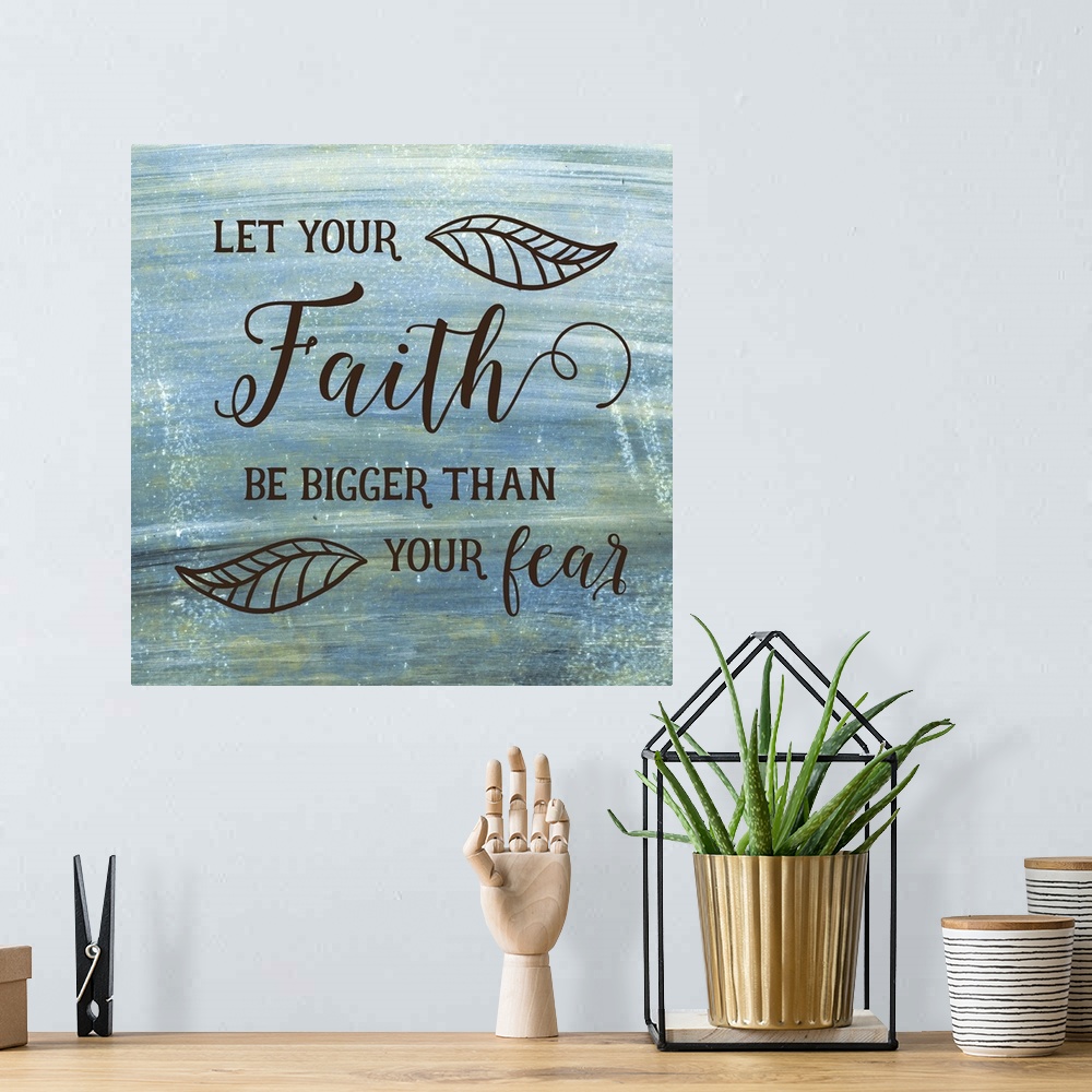 A bohemian room featuring Typography art of a religious sentiment with a leaf motif over a weathered blue and green backgro...