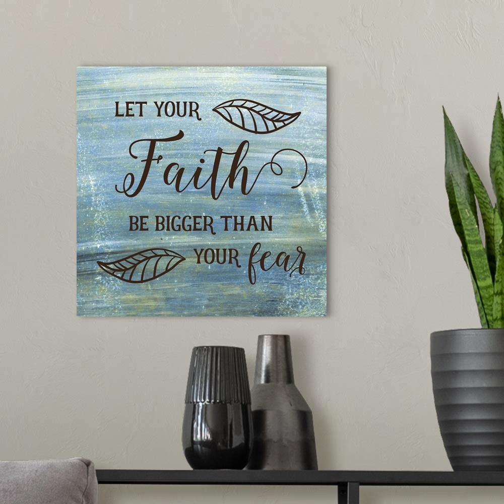 A modern room featuring Typography art of a religious sentiment with a leaf motif over a weathered blue and green backgro...
