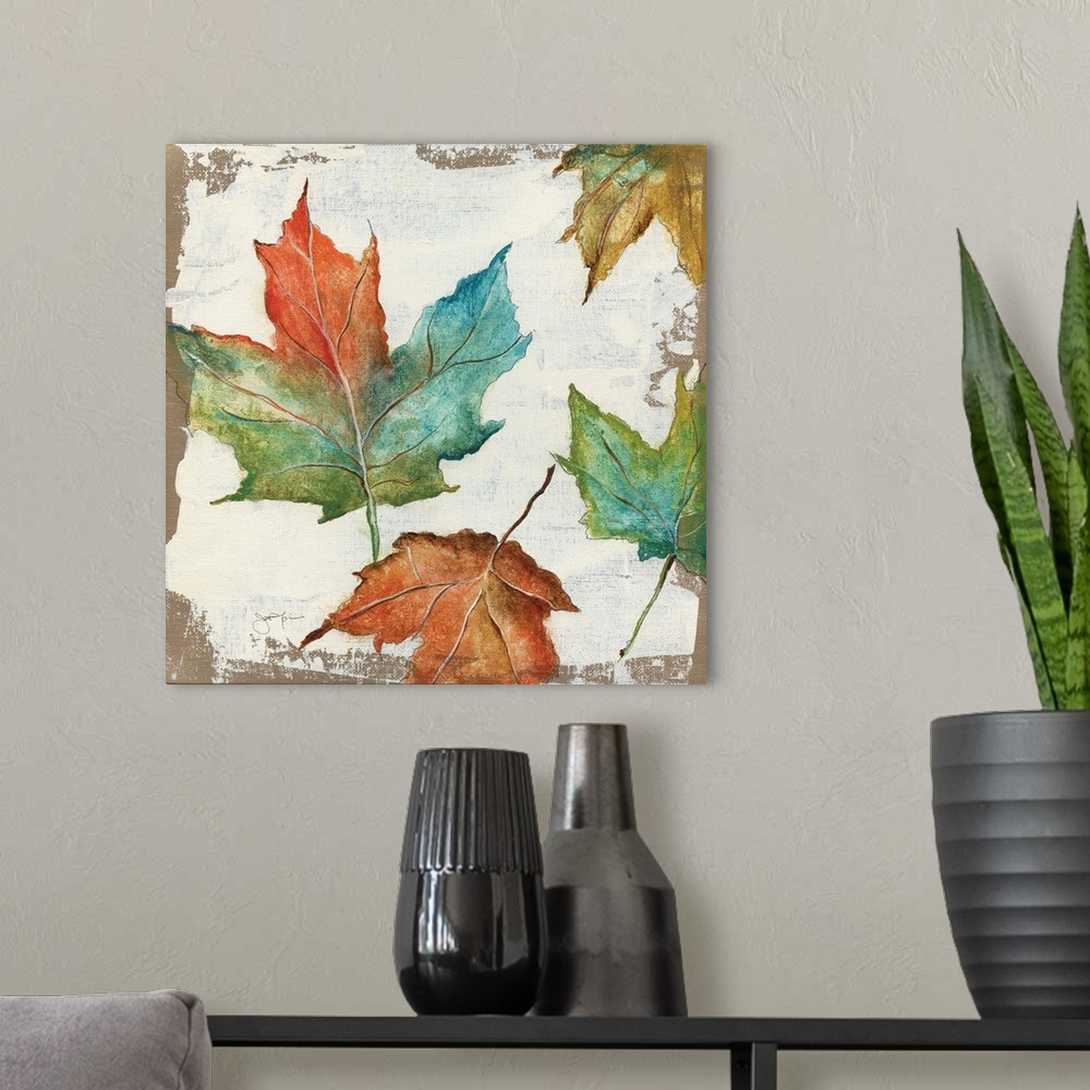 A modern room featuring Autumn home decor artwork with multicolored Fall leaves.