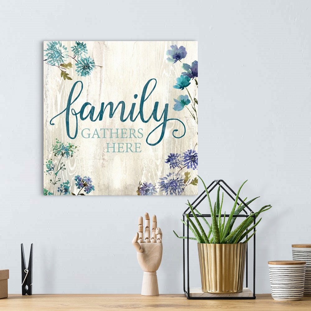 A bohemian room featuring Decorative watercolor artwork of a group of flowers with the text "Family Gathers Here".