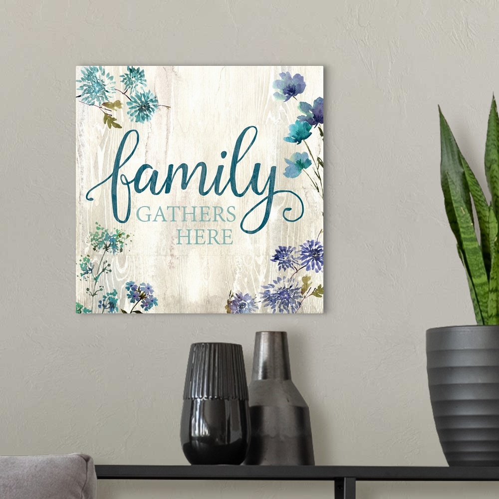 A modern room featuring Decorative watercolor artwork of a group of flowers with the text "Family Gathers Here".