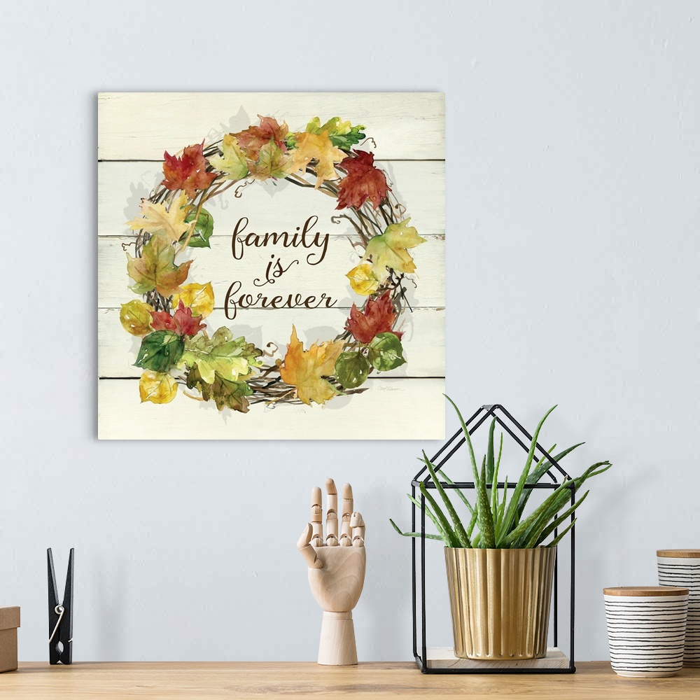 A bohemian room featuring A wreath of various leafs and branches surround the words, "Family is Forever".
