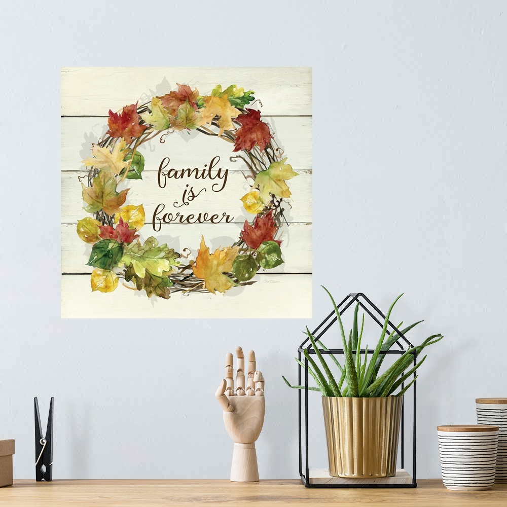 A bohemian room featuring A wreath of various leafs and branches surround the words, "Family is Forever".