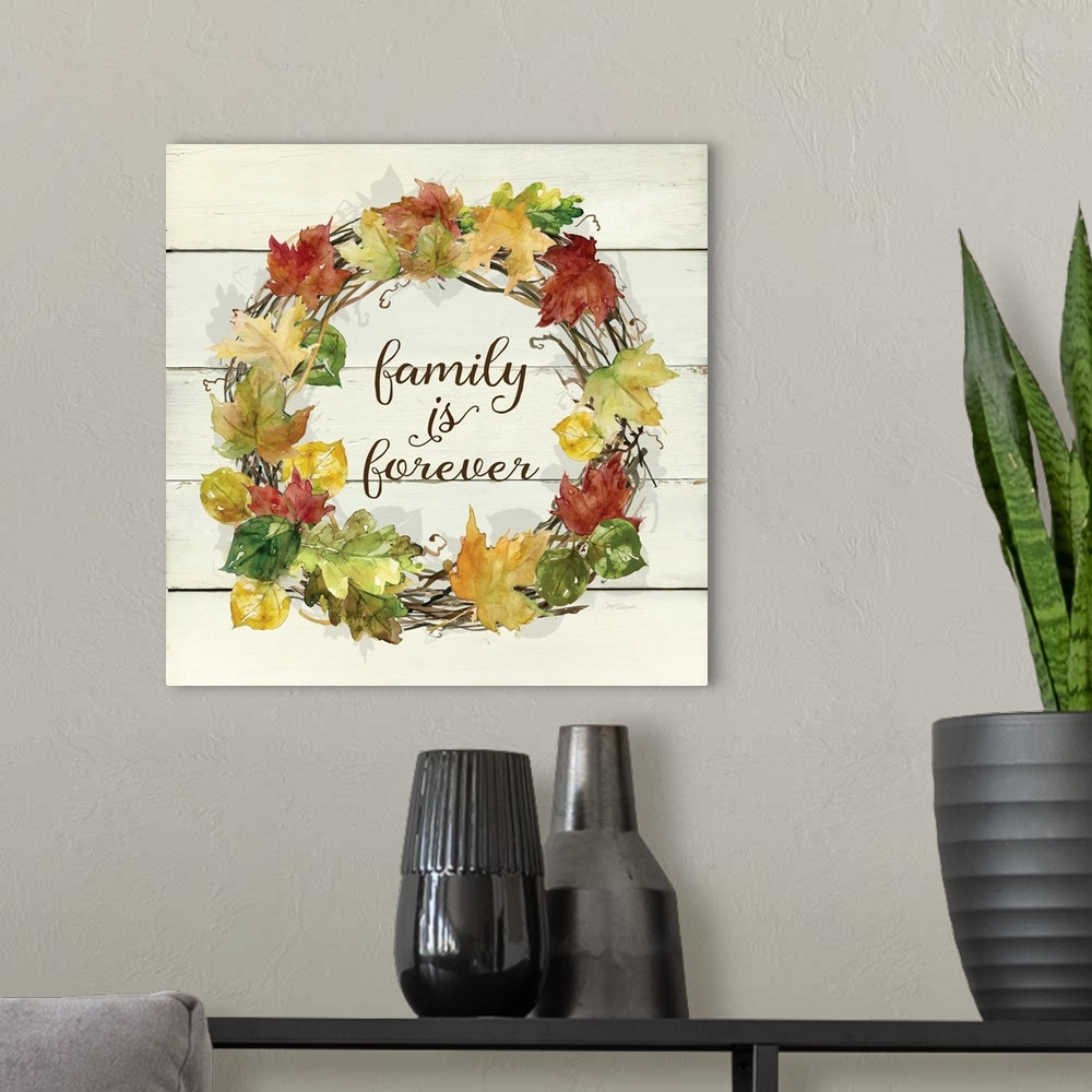 A modern room featuring A wreath of various leafs and branches surround the words, "Family is Forever".