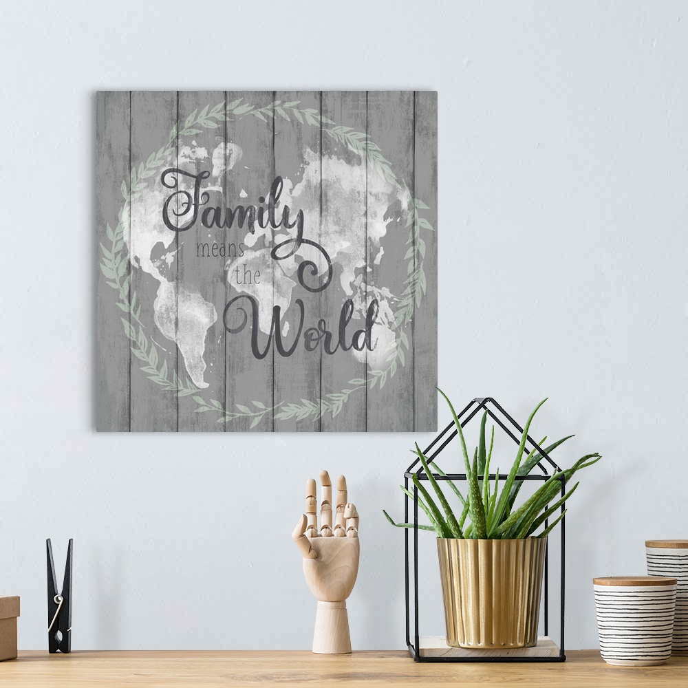 A bohemian room featuring Square decorative artwork of a map of world with a wreath around it and the text 'Family Means Th...