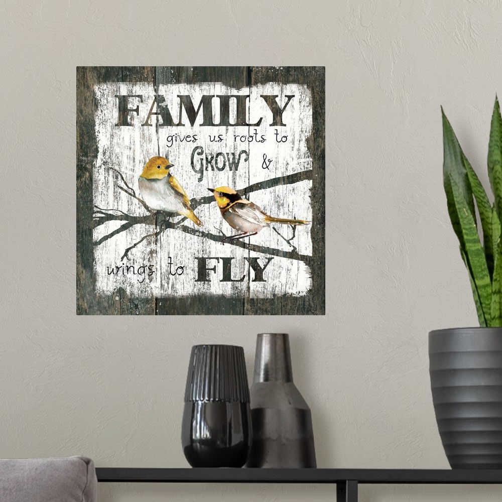 A modern room featuring A decorative painting of two birds sitting on branches and the text ?Family gives us roots to Gro...