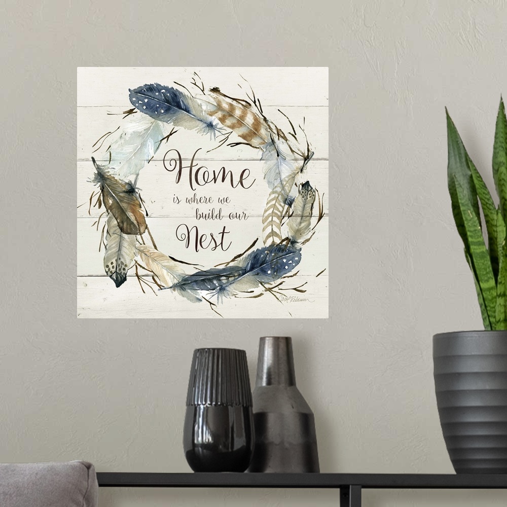 A modern room featuring Square watercolor painting with a wreath made of feathers and the phrase "Home is Where We Build ...