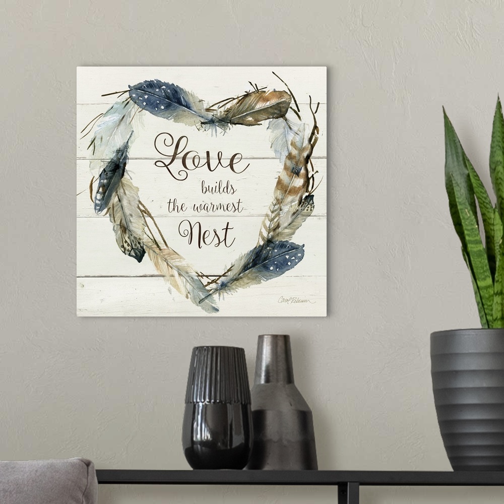 A modern room featuring Square watercolor painting with a heart shaped wreath made of feathers and the phrase "Love Build...