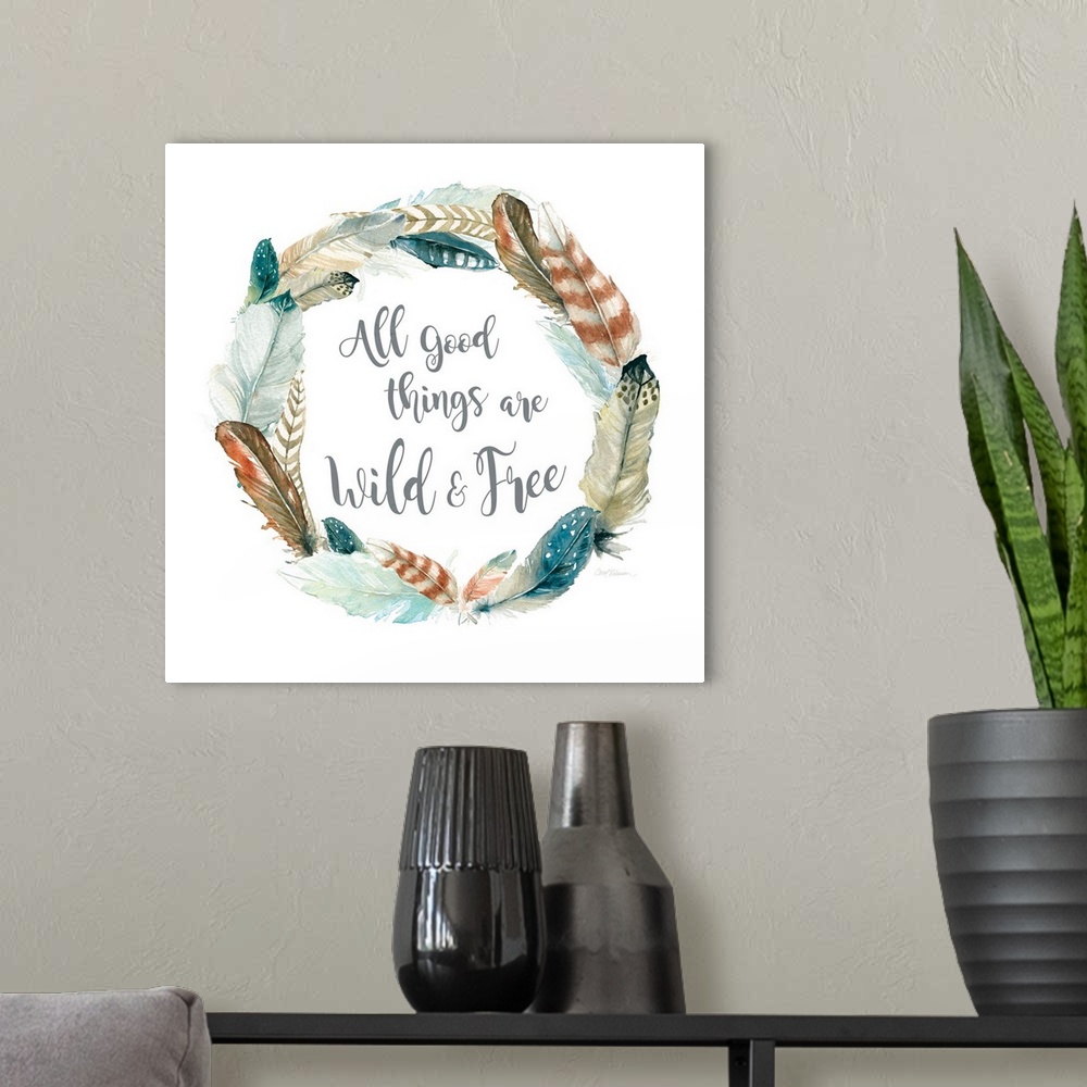 A modern room featuring Square watercolor painting with a wreath made of feathers and the phrase "All Good Things Are Wil...