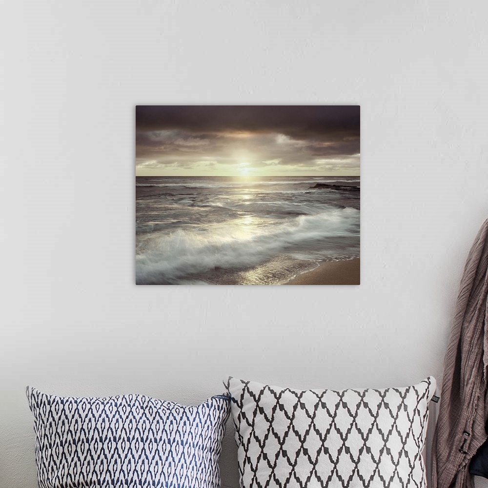A bohemian room featuring Long exposure photograph of waves crashing on the shore with an evening sunset and a cloudy sky.