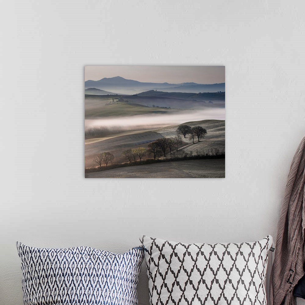 A bohemian room featuring Photograph of rolling fields covered in mist with mountains in the background.