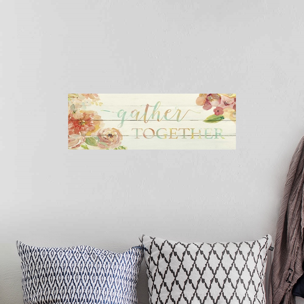 A bohemian room featuring "Gather Togther" written on a faux wood panel background with painted pink flowers on the sides.
