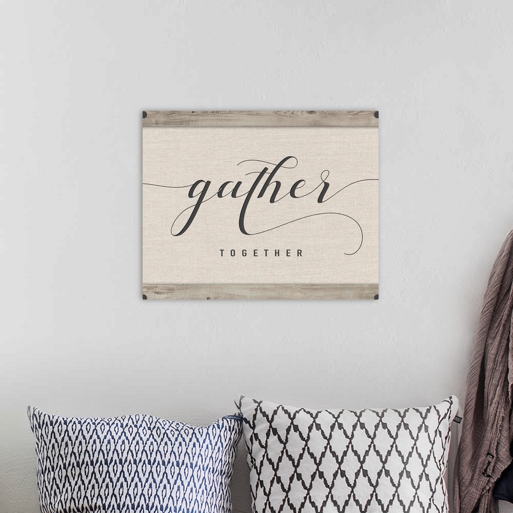 A bohemian room featuring 'Gather Together' neutral colored square sign.