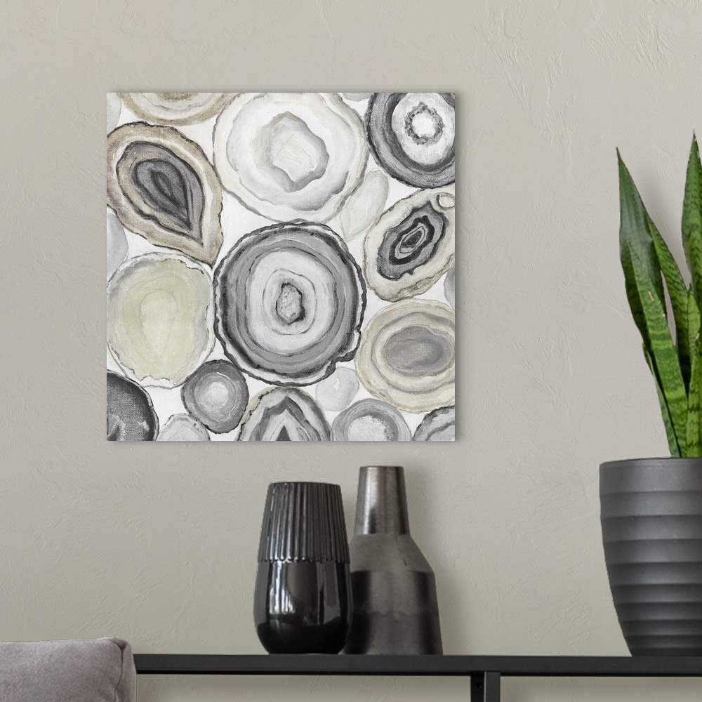A modern room featuring Square painting of rocks cut in half displaying neutral toned agate.