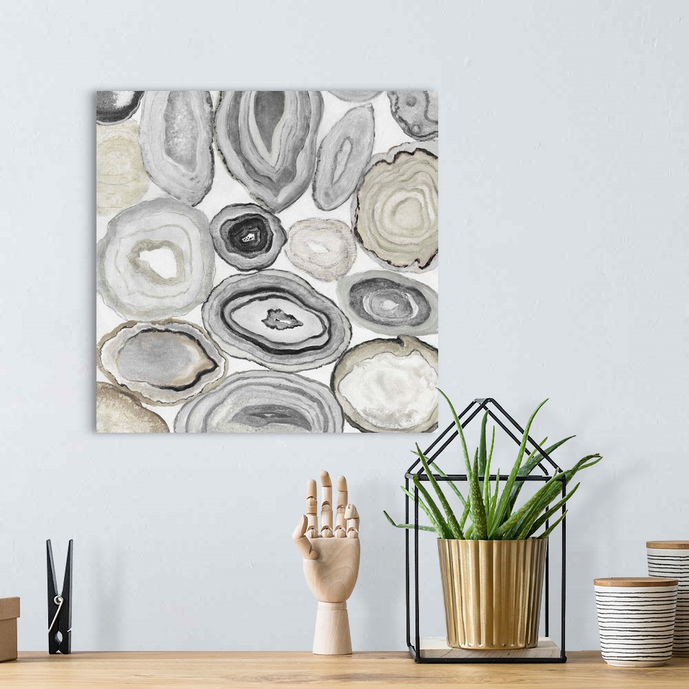 A bohemian room featuring Square painting of rocks cut in half displaying neutral toned agate.