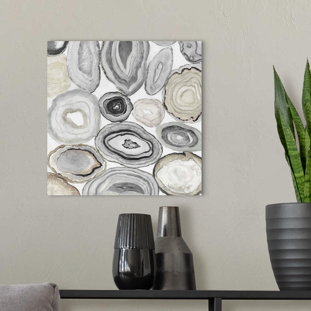 A modern room featuring Square painting of rocks cut in half displaying neutral toned agate.