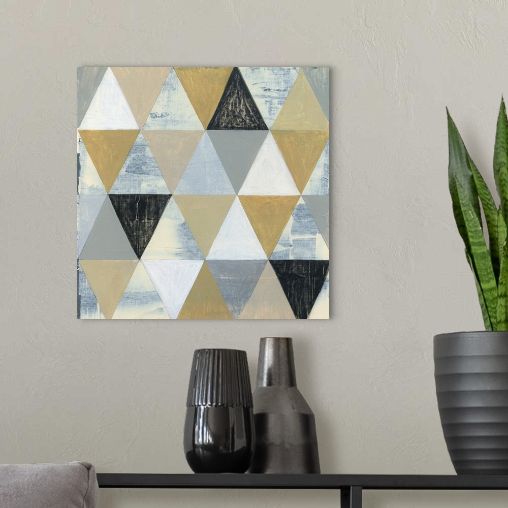 A modern room featuring Geometric abstract art with triangular shapes coming together to create a pattern in shades of gr...