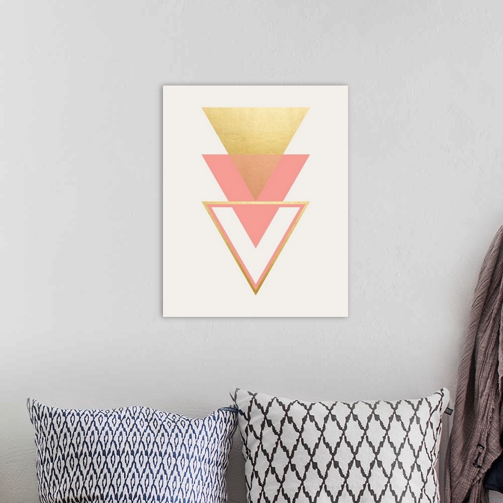 A bohemian room featuring A vertical geometric design of a trio of triangles in pink and gold.