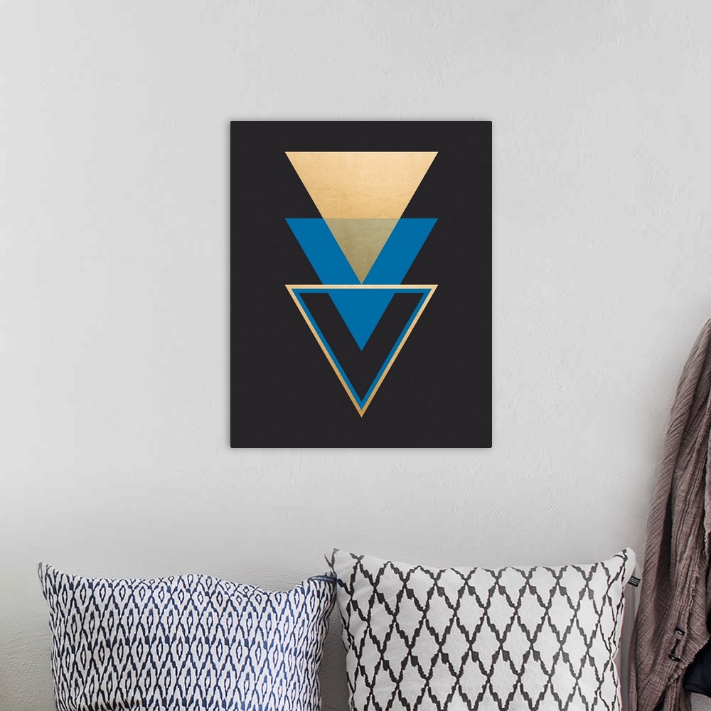 A bohemian room featuring A vertical geometric design of a trio of triangles in blue and gold on a black background.