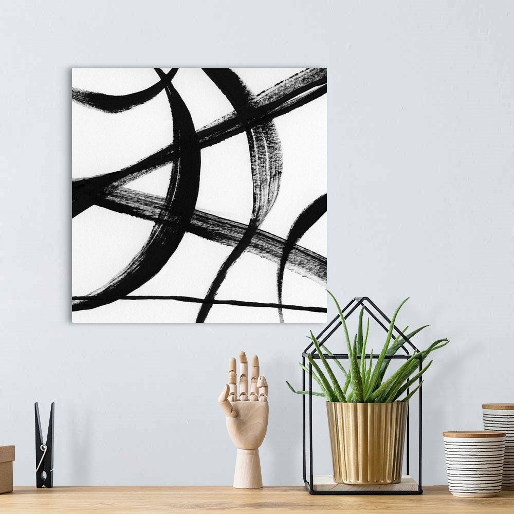 A bohemian room featuring Square black and white abstract painting with thick, bold, curvy lines.