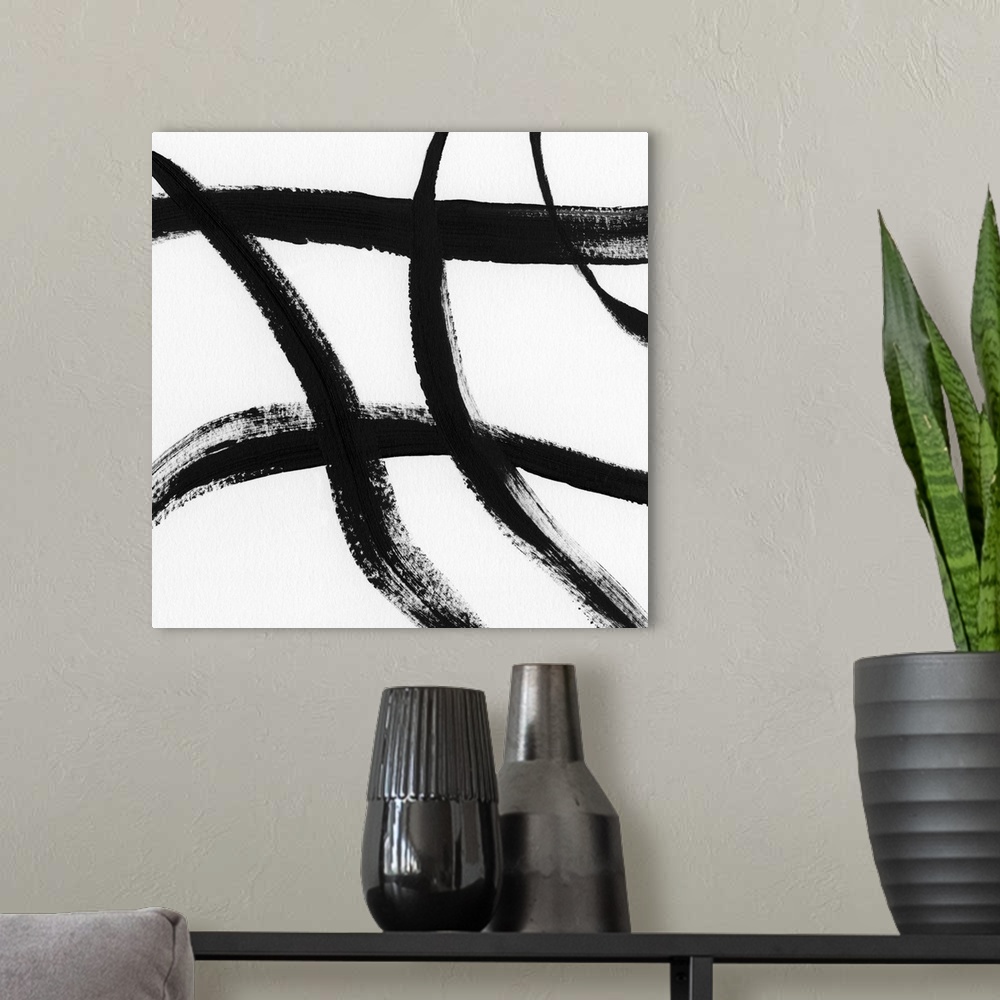 A modern room featuring Square black and white abstract painting with thick, bold, crossing lines.