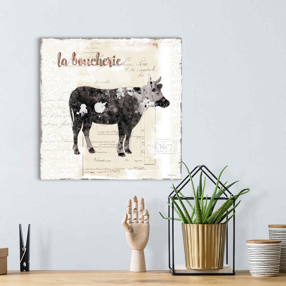 A bohemian room featuring A decorative painting of cow with a background that is beige with white deigns and a French writing.