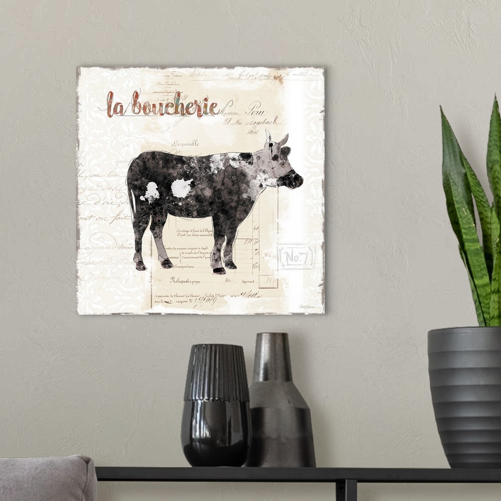 A modern room featuring A decorative painting of cow with a background that is beige with white deigns and a French writing.